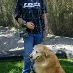 Trainer standing with a golden retriever outdoors