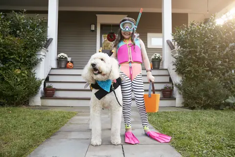 Woman in Halloween snorkel costume with her dog in matching gear